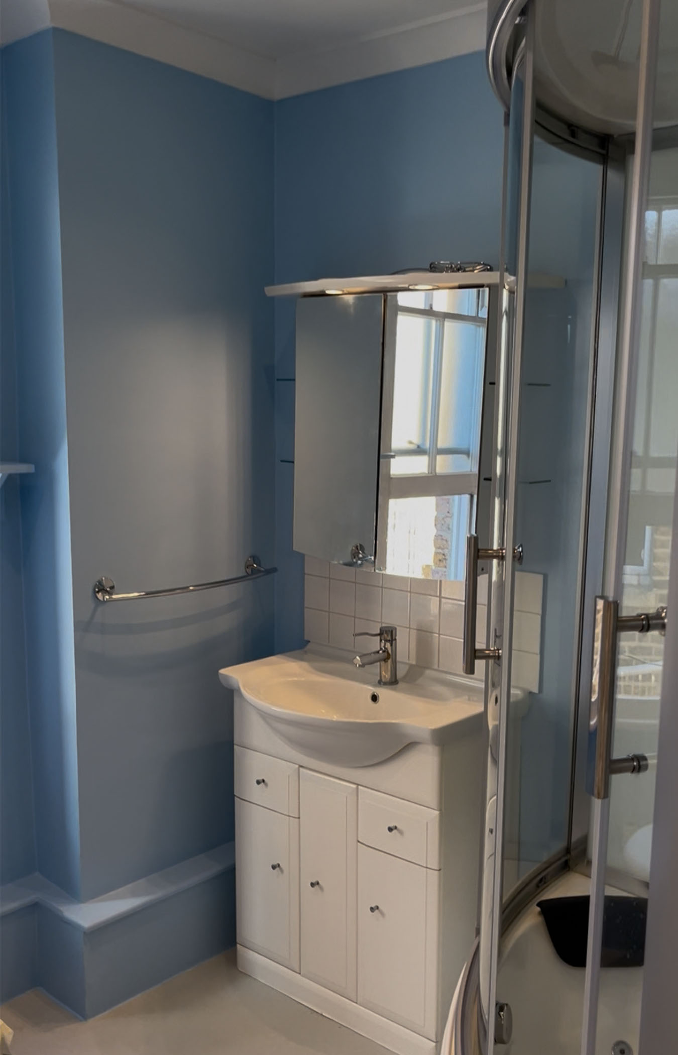 Renovated bathroom with freshly painted blue walls