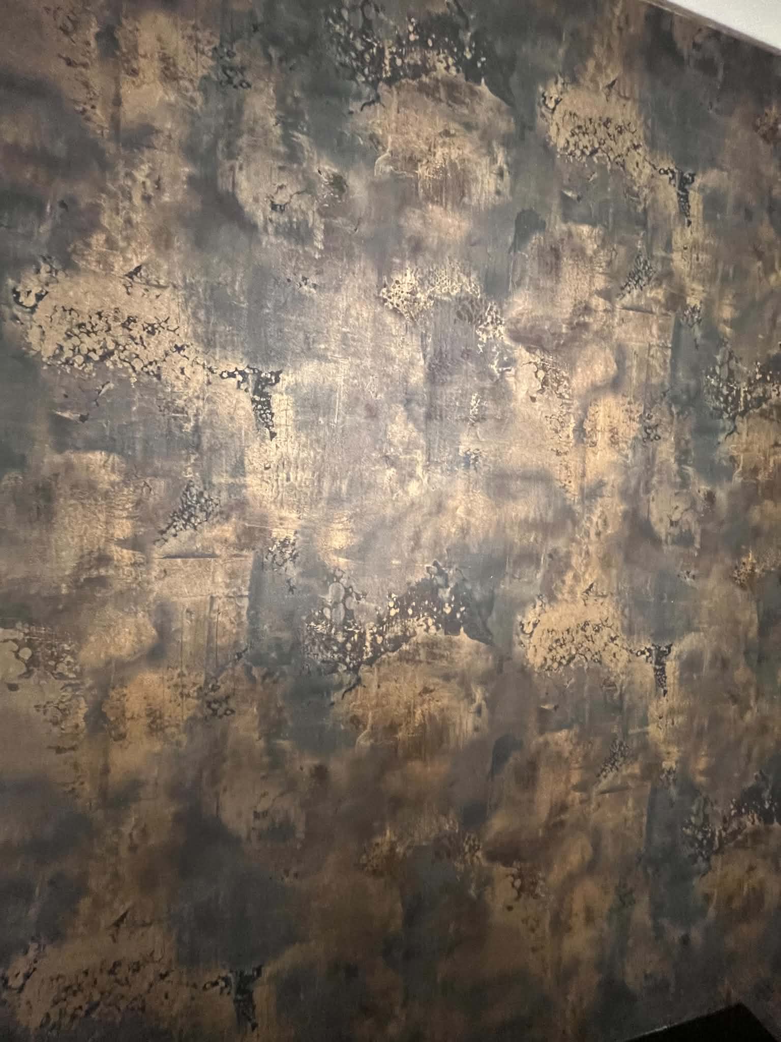 Textured metallic decorative wall finish in bronze and charcoal tones