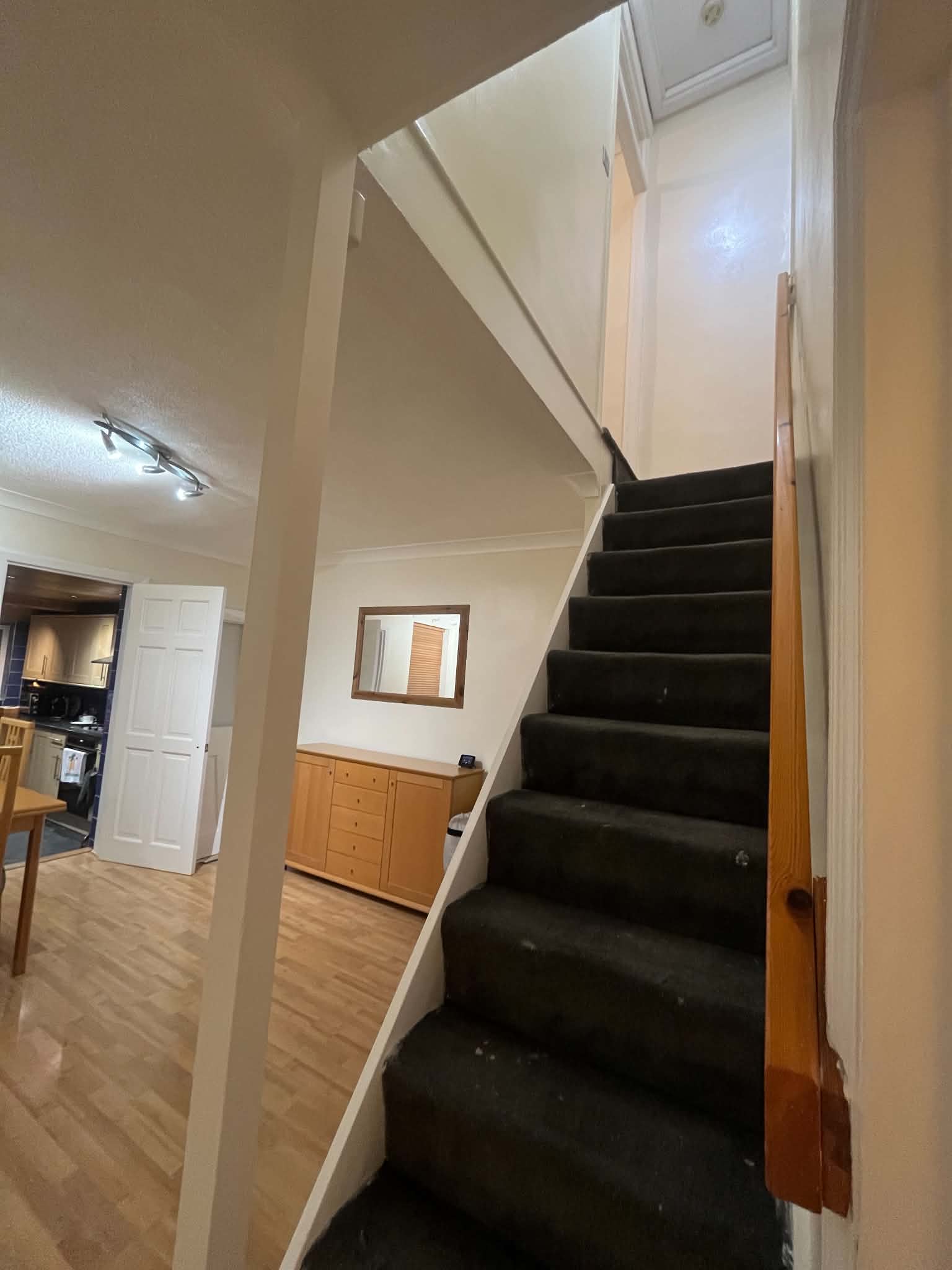 Dark carpeted staircase before painting and redecoration